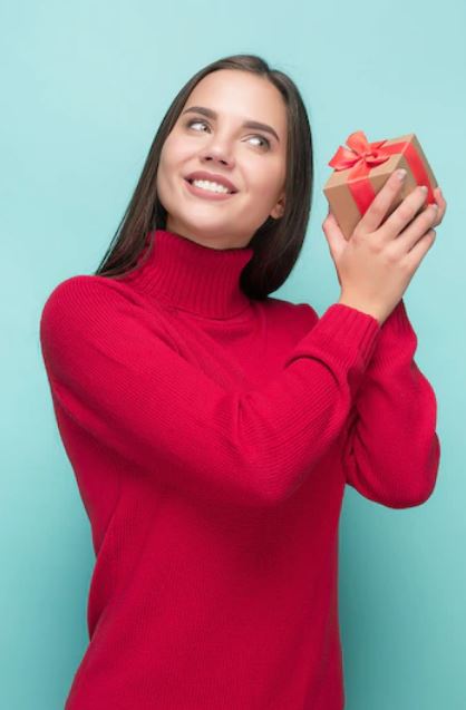 Corporate woman wondering what is inside the branded giveaway surprise that she just received